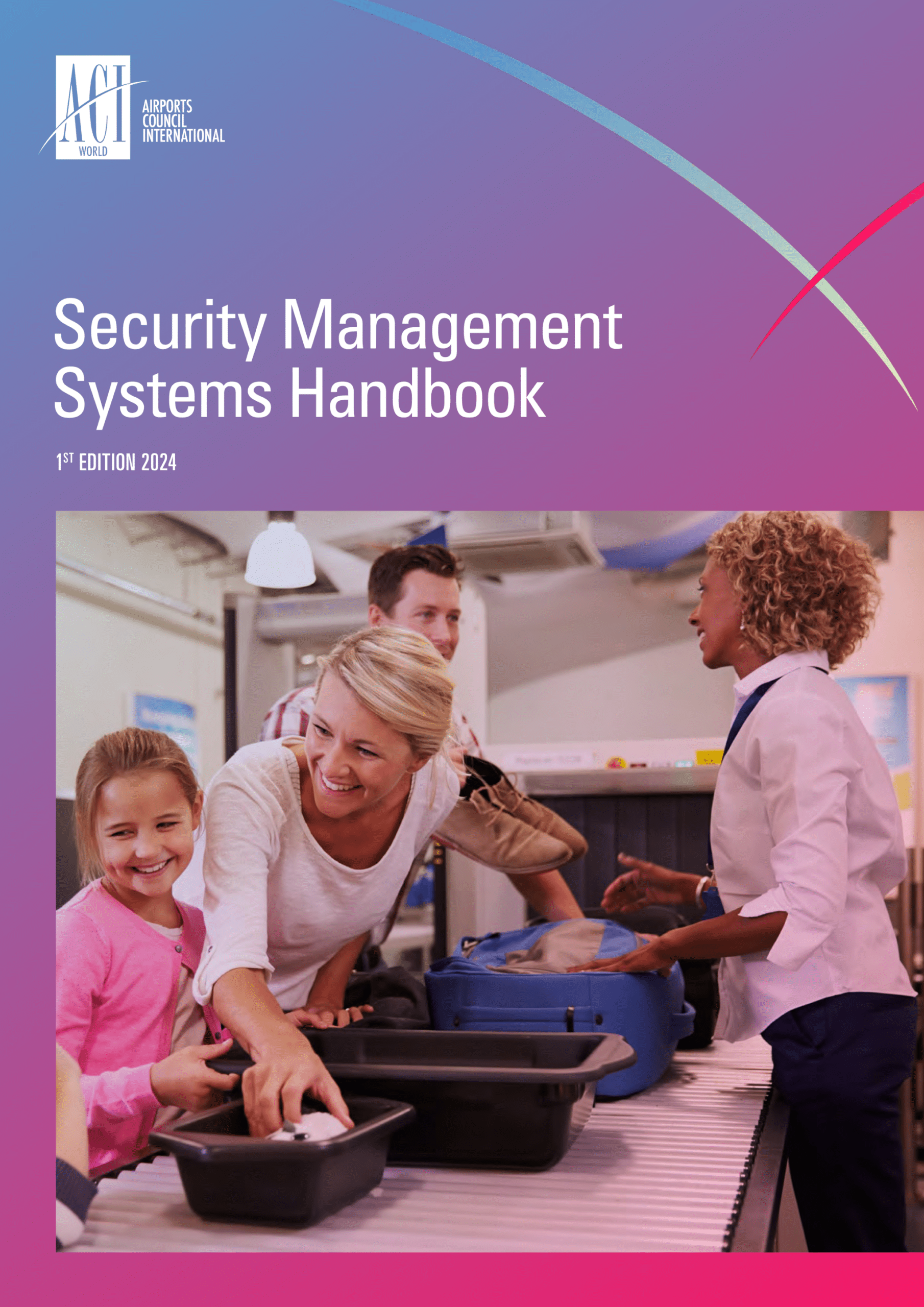 A smiling woman and a young girl place luggage trays on an airport security conveyor belt, assisted by a security officer; other passengers and security equipment are visible in the background.