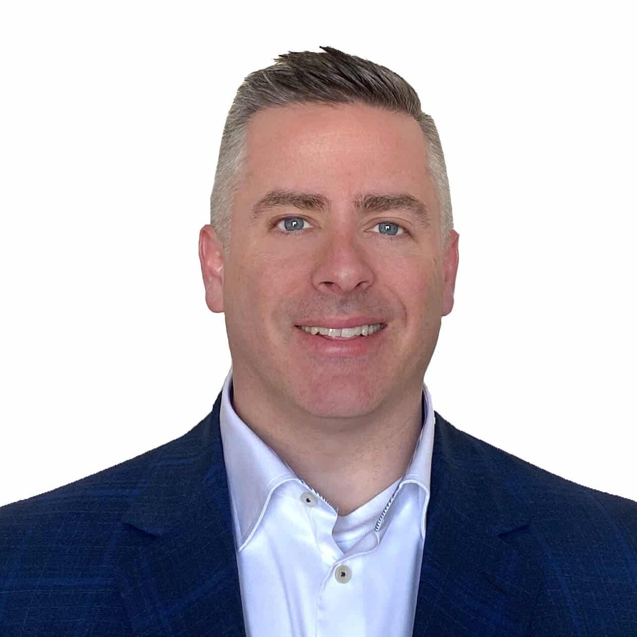 A man with short, neatly styled hair wearing a dark blue blazer and white dress shirt, smiling at the camera against a plain white background.